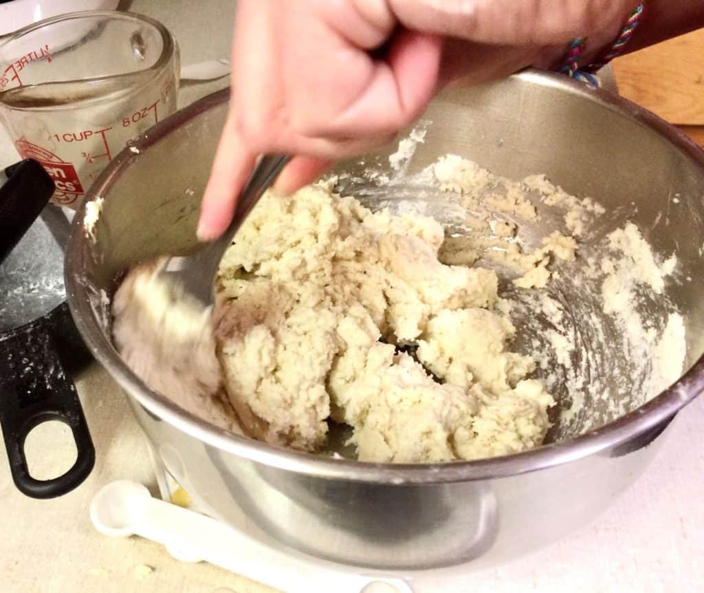 Using a fork to add the wet ingredients to your grain free biscuit dough