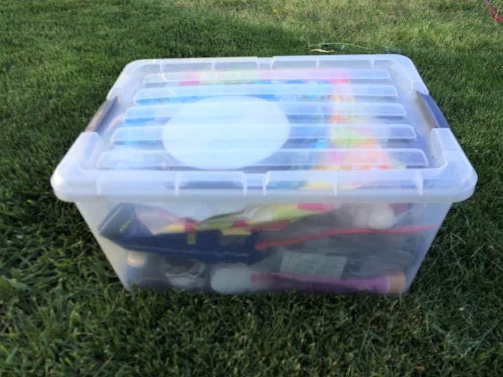 Clear plastic lake bin with essentials for what to bring to the lake for the day