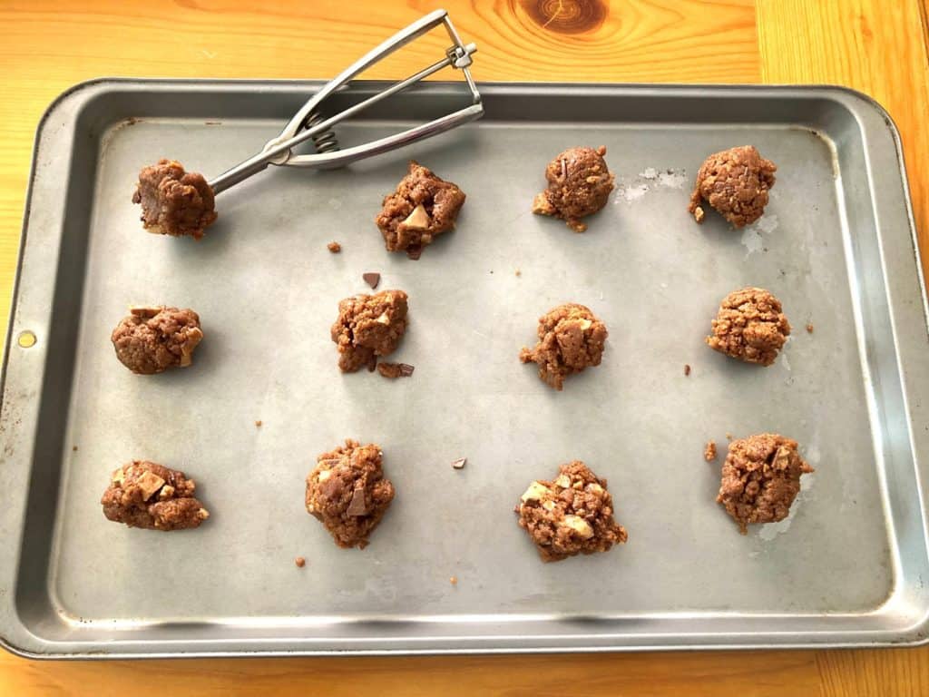 scooped almond butter cookie dough onto cookie sheet