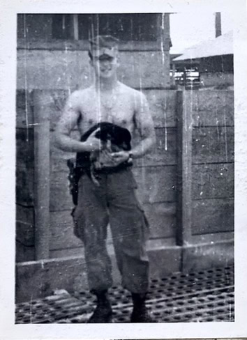 soldier holding a dog