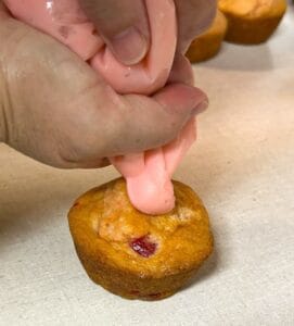 cut tip of baggie and put one dollop of frosting on cupcake