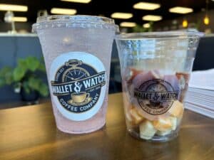 Two cups with fizzy drink and snacks