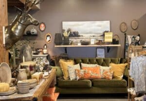 long green couch with orange pillows